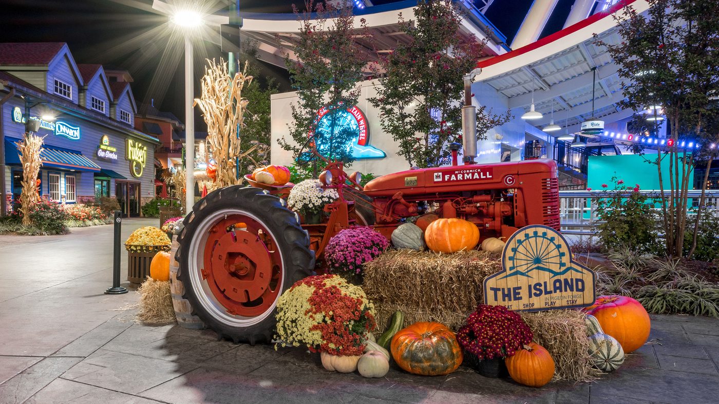 Red Farmall tractor and pumpkin display at The Island in Pigeon Forge during Autumn's GLOW.